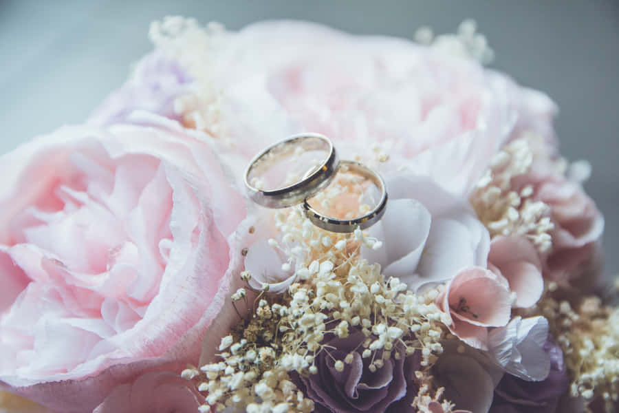 Two Wedding Rings On Wedding Flowers